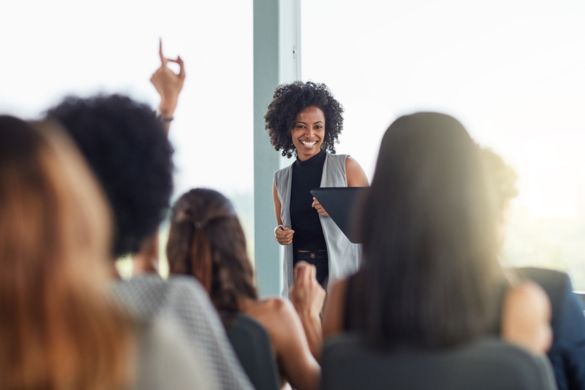 a woman speaks at a corporate event
