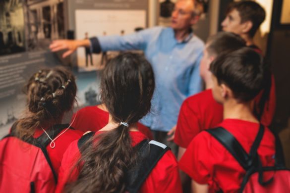 a group of students gather at a museum