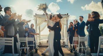 two brides celebrate their marriage at a beach wedding